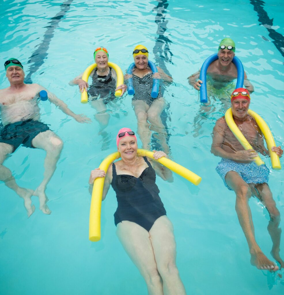 pikwizard-swimmers-swimming-with-pool-noodles
